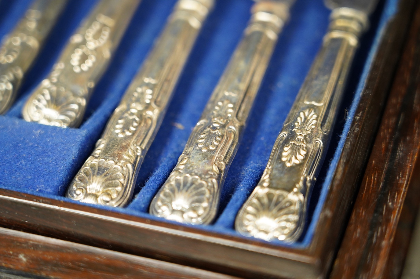 A cased set of six silver handled tea knives and six other cased plated sets. Condition - fair